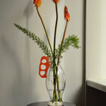 Discover the Modern Vintage Guta Glass Vase with Red Handle – a handcrafted consignment piece, blending traditional craftsmanship with bold modern design.