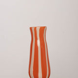 Discover the YAKUSH STRIPS Vase Orange – an 8.6" tall, jam orange striped recycled glass vase, handmade for drinks or floral displays.